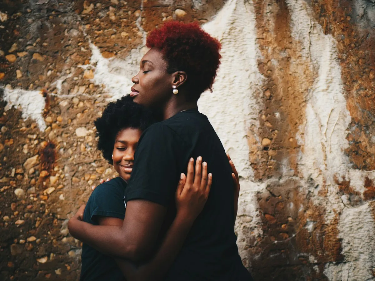 A mother and her daughter holding each other in a close embrace